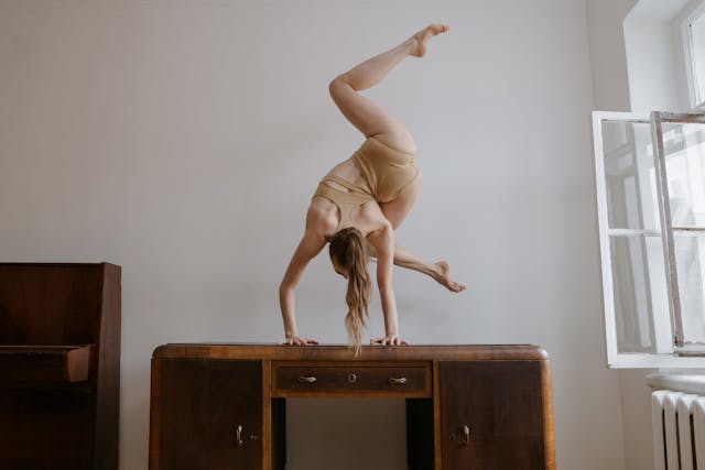 woman moving in yoga pose on desk