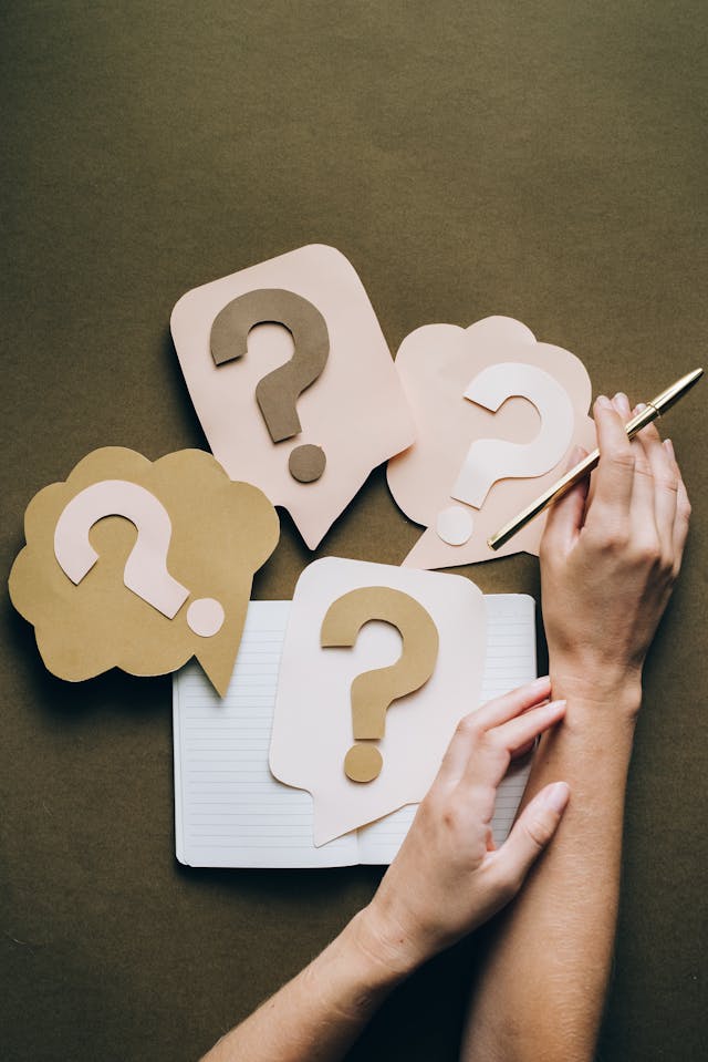 question marks and notebook highlighting decision making